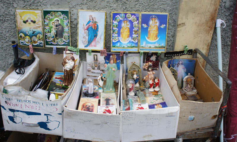 Votive offerings for sale at a shrine in the village of Quatre Bornes.