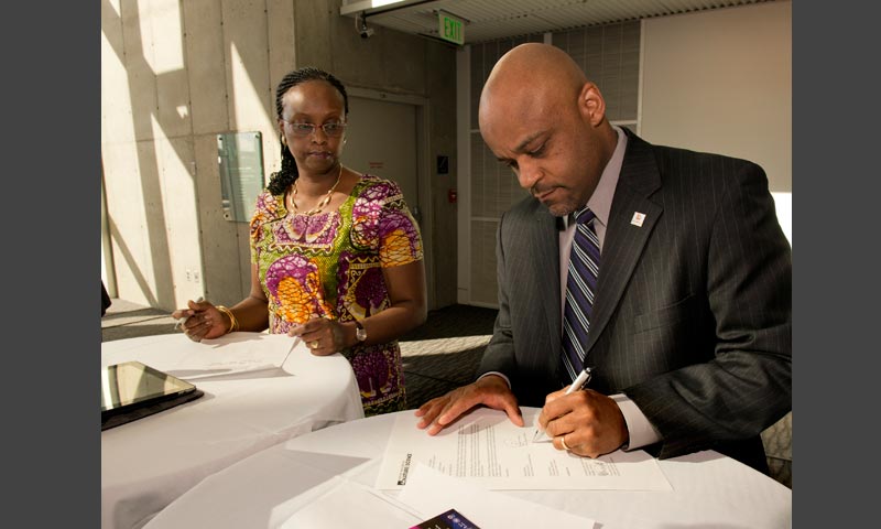 Denver Mayor Michael B. Hancock and Kenyan Ambassador to the U.S. Jean Njeri Kamau sign the agreement transferring the vigango to the National Museums of Kenya, which will facilitate the return of the vigango to their source communities.