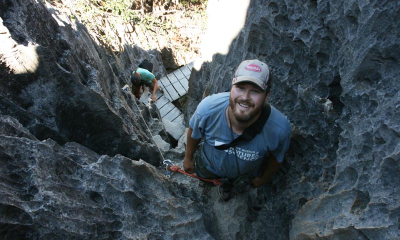 Image of Dr. Ian Miller, curator of paleontology, climbing one of many trails through the limestone spires of Tsingy de Bemaraha National Park.